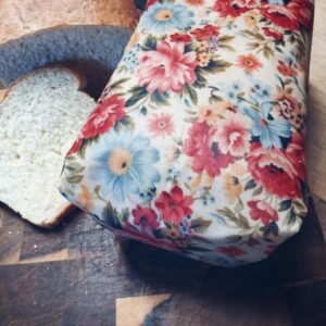 Homemade sliced white bread unwrapped and wrapped in floral beeswax wrap