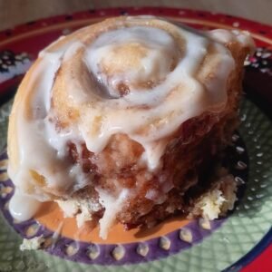 Iced cinnamon roll on a plate